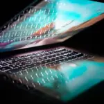 Microsoft 365 Weekly Change Intelligence | 24th-30th August 2026 1 Modern laptop with illuminated keyboard and screen reflection on a dark background.